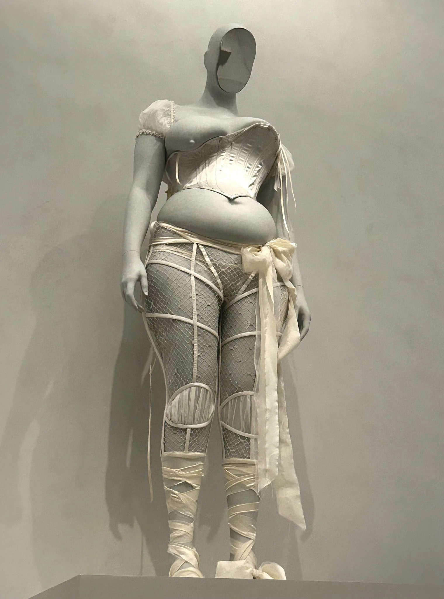 Maison Margiela, John Galliano (British, born Gibraltar, 1960). Ensemble, autumn/winter 2020–21 haute couture; alongside Rafaello Monti (Italian, 1818–1881), The Veiled Woman, 1854, marble. Photo: Lanney Jing.